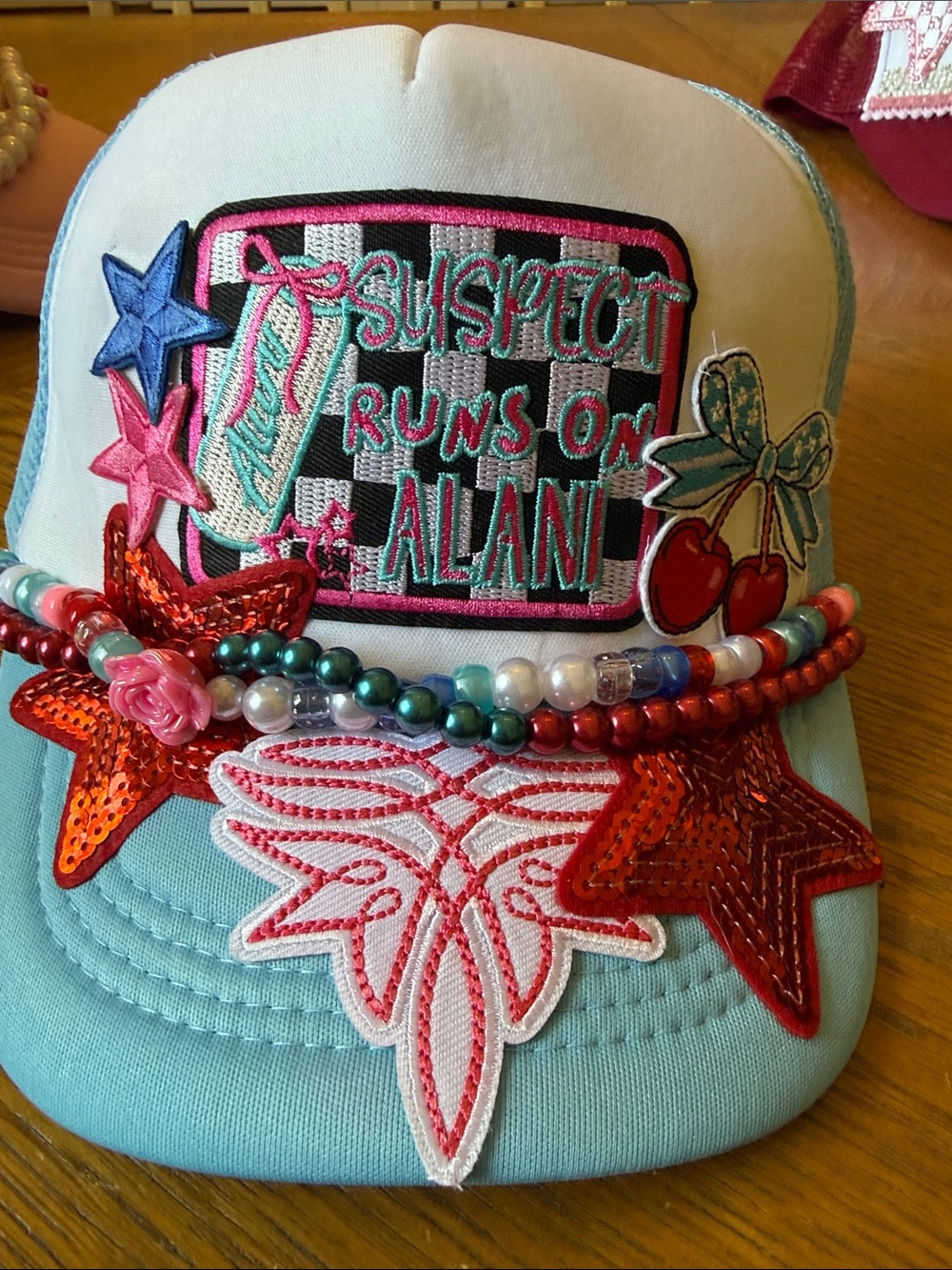 Blue Embellished Trucker Hat with Multicolor Patches and Beads Runs on Alani